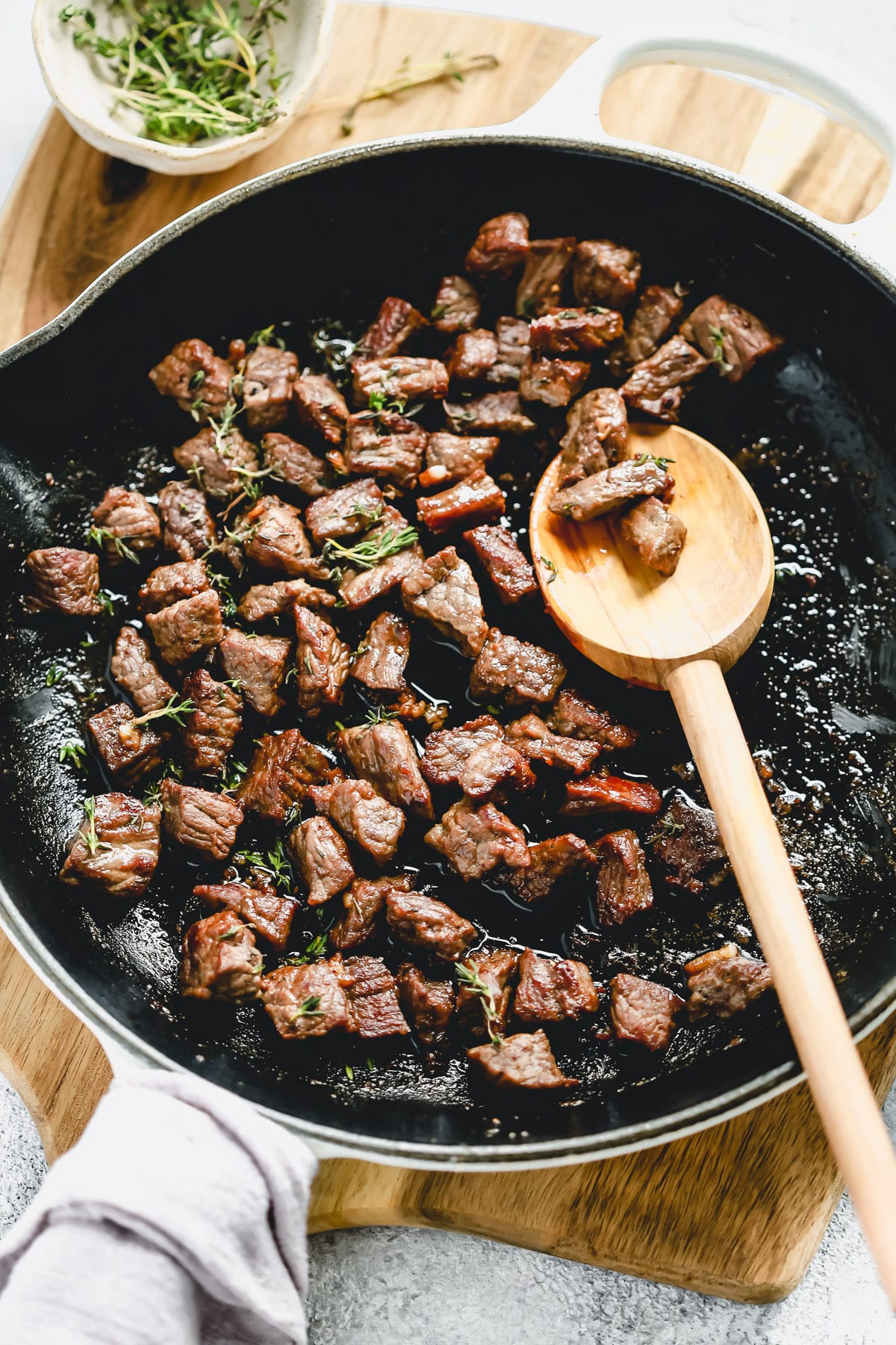 steak bites cooking in a skillet