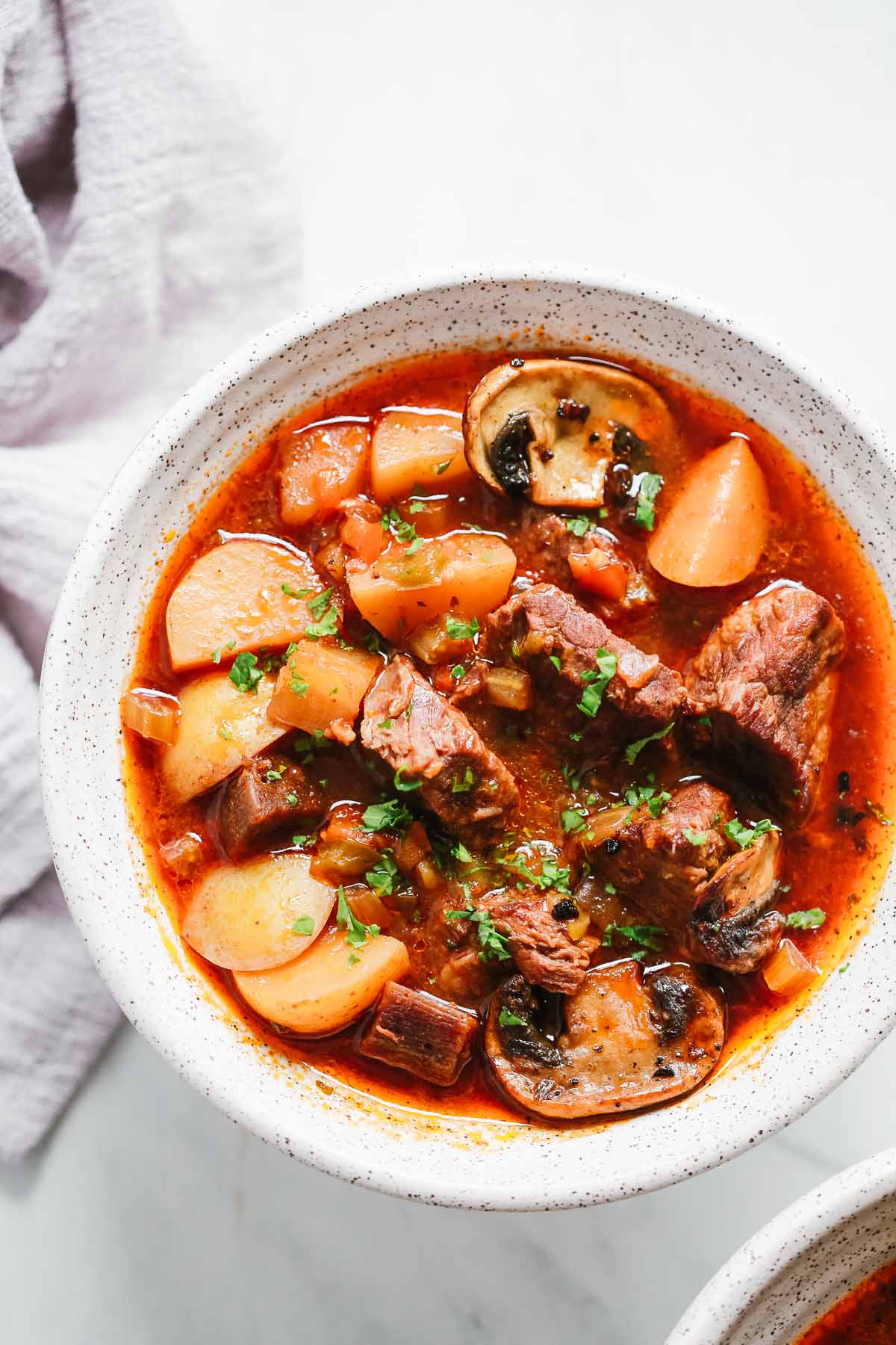 White bowl containing Instant Pot beef stew.