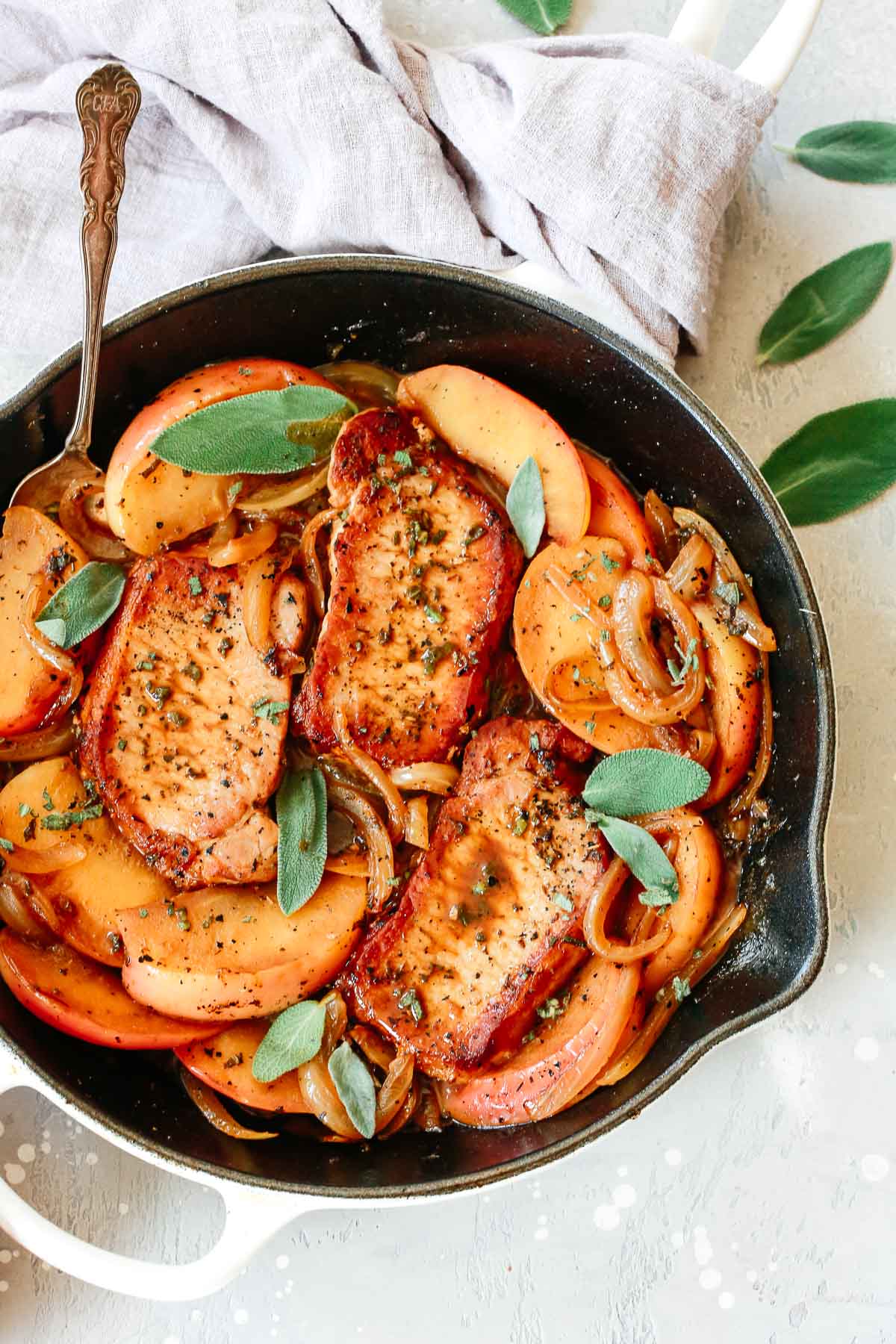 pork chops and apple slices in skillet