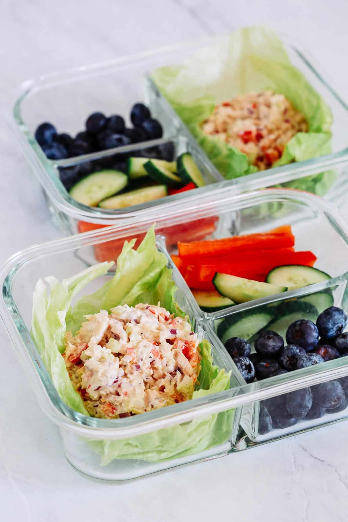 close up of Tuna Salad in a glass containers with veggies