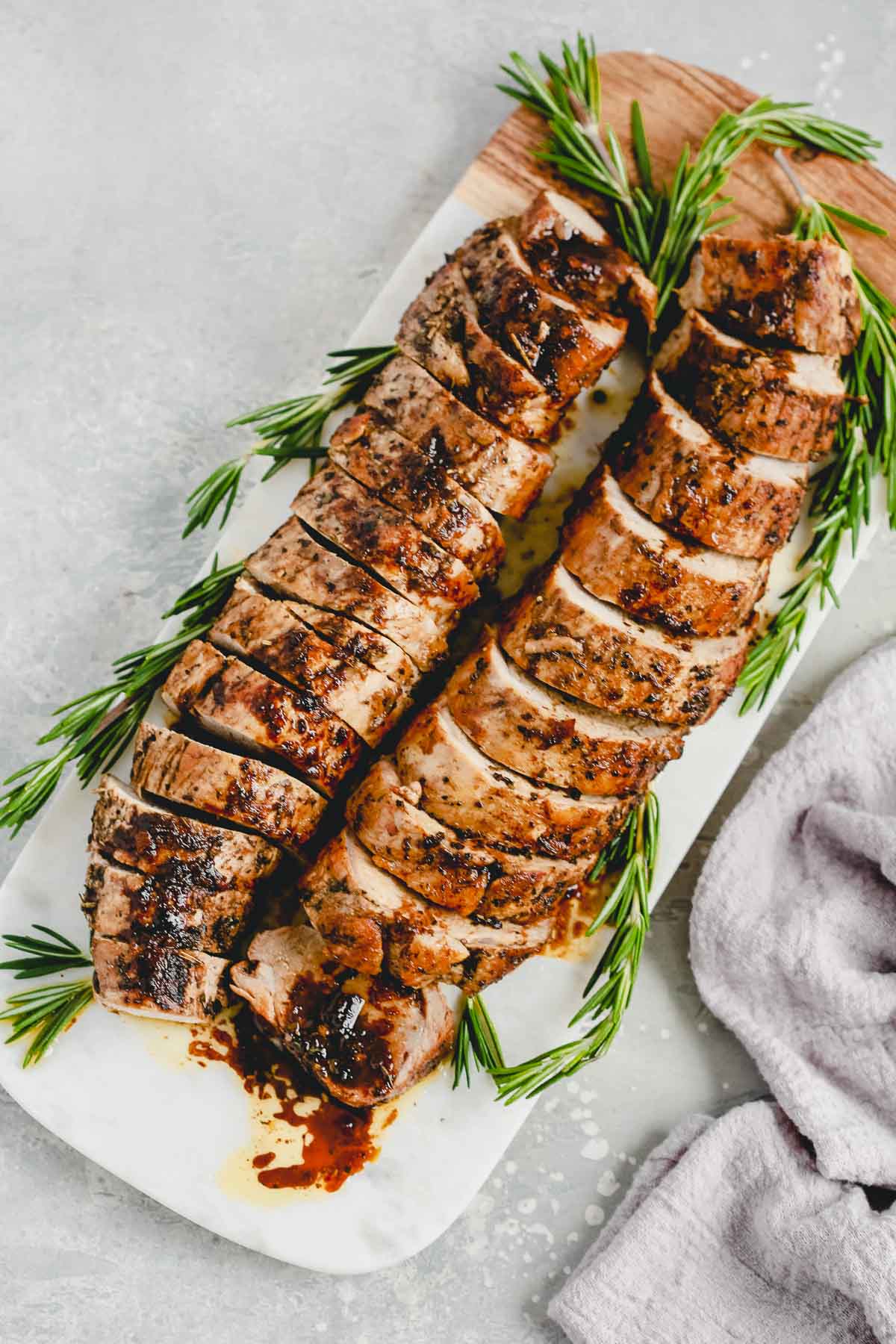 overhead view of balsamic Roast Pork Tenderloin on a marble board 