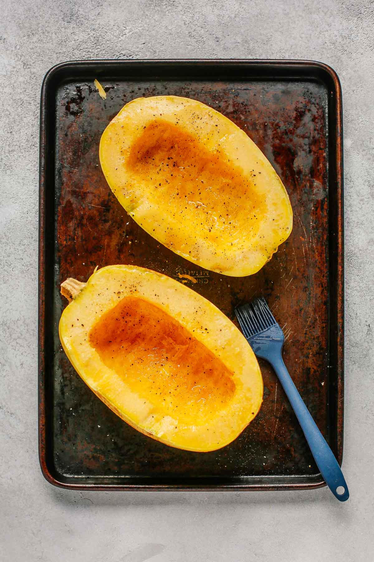 spaghetti squash cut in half without seeds and with olive oil, salt and pepper