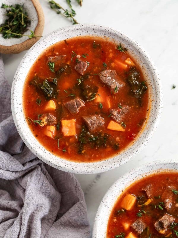 Instant Pot Sweet Potato Kale Beef Soup in a bowl headshot