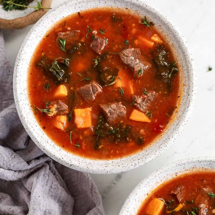 Instant Pot Sweet Potato Kale Beef Soup in a bowl headshot