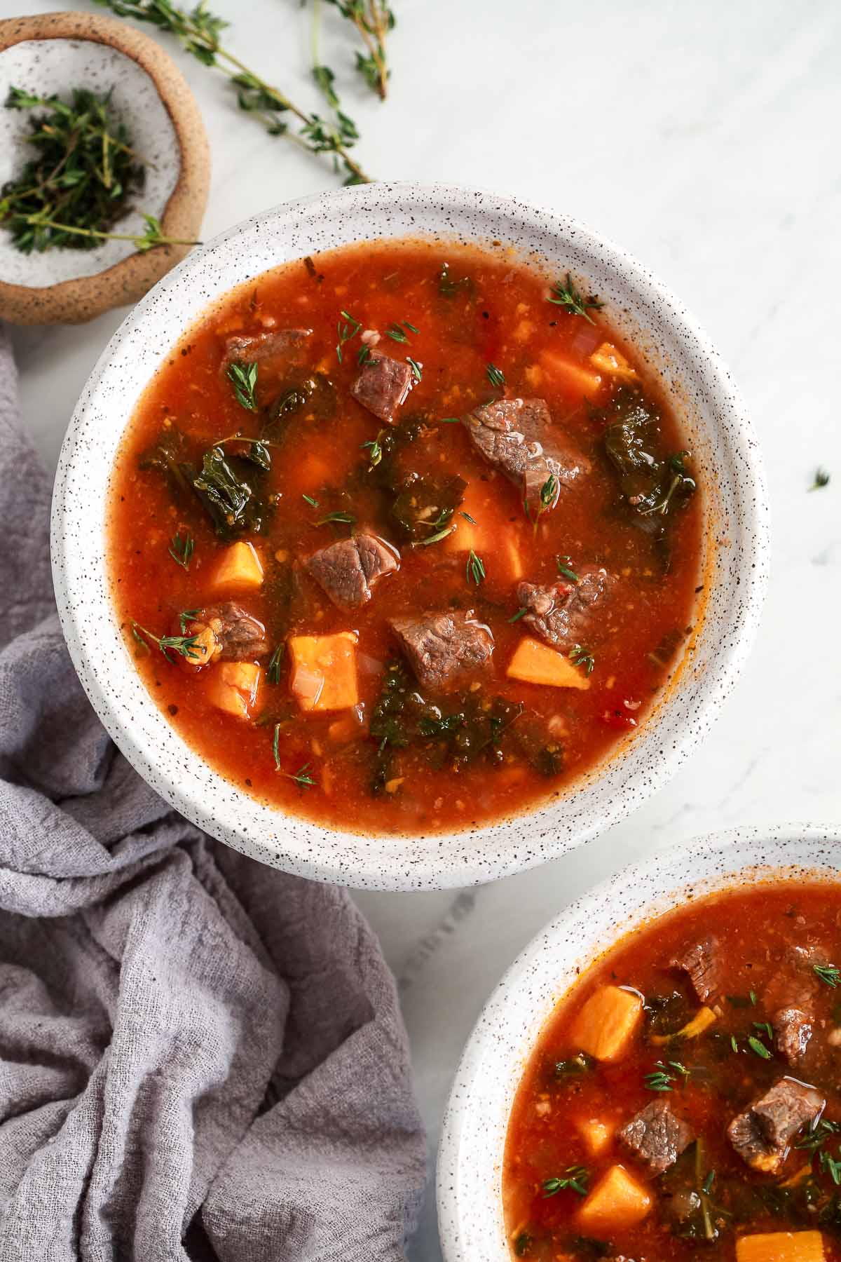 Instant Pot Sweet Potato Kale Beef Soup in a bowl headshot 