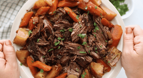 overhead view of pot roast in a white plate