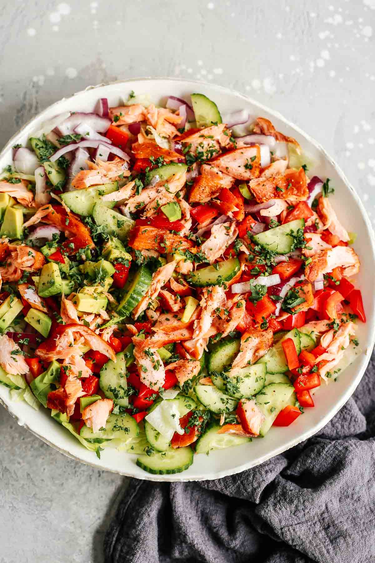 overhead image of fish salad with vegetables and salmon