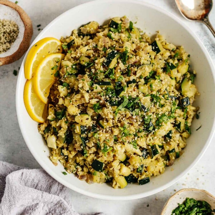 Overhead photo of a white bowl with zucchini cauliflower rice.