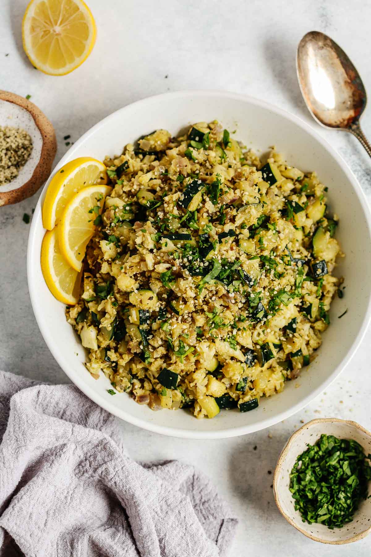 Overhead photo of a white bowl with zucchini cauliflower rice.