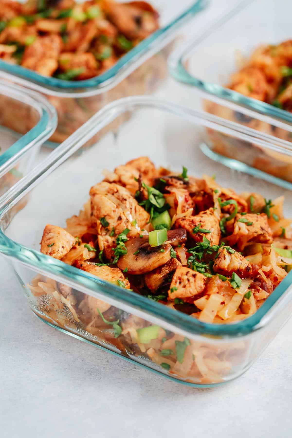 small glass bowls containing chicken and cabbage