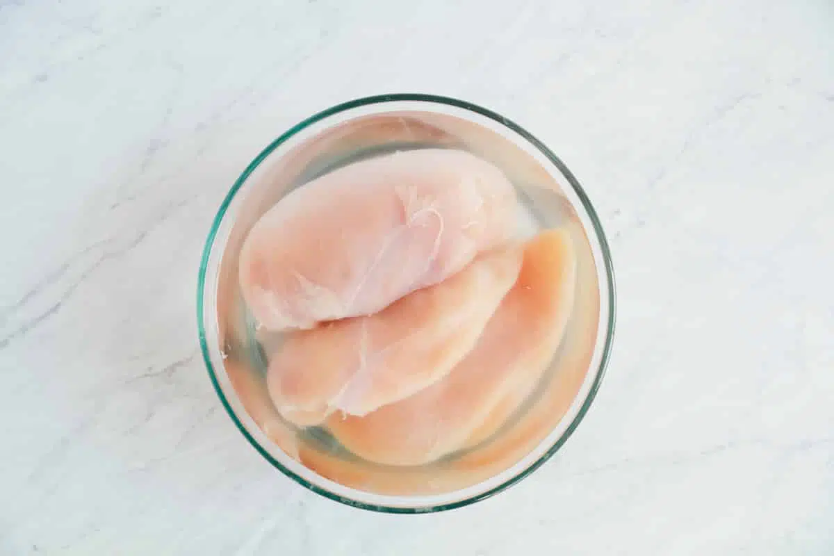 brining chicken breasts in glass bowl