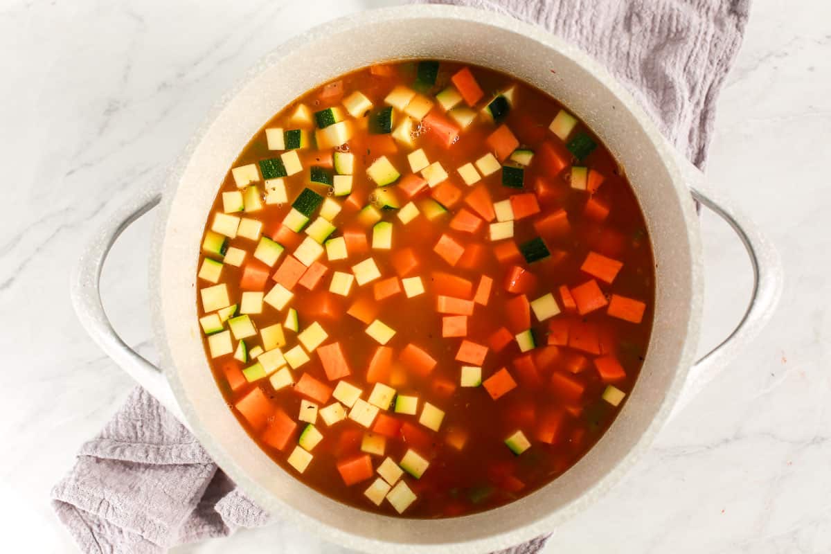 vegetables and broth in a soup pot