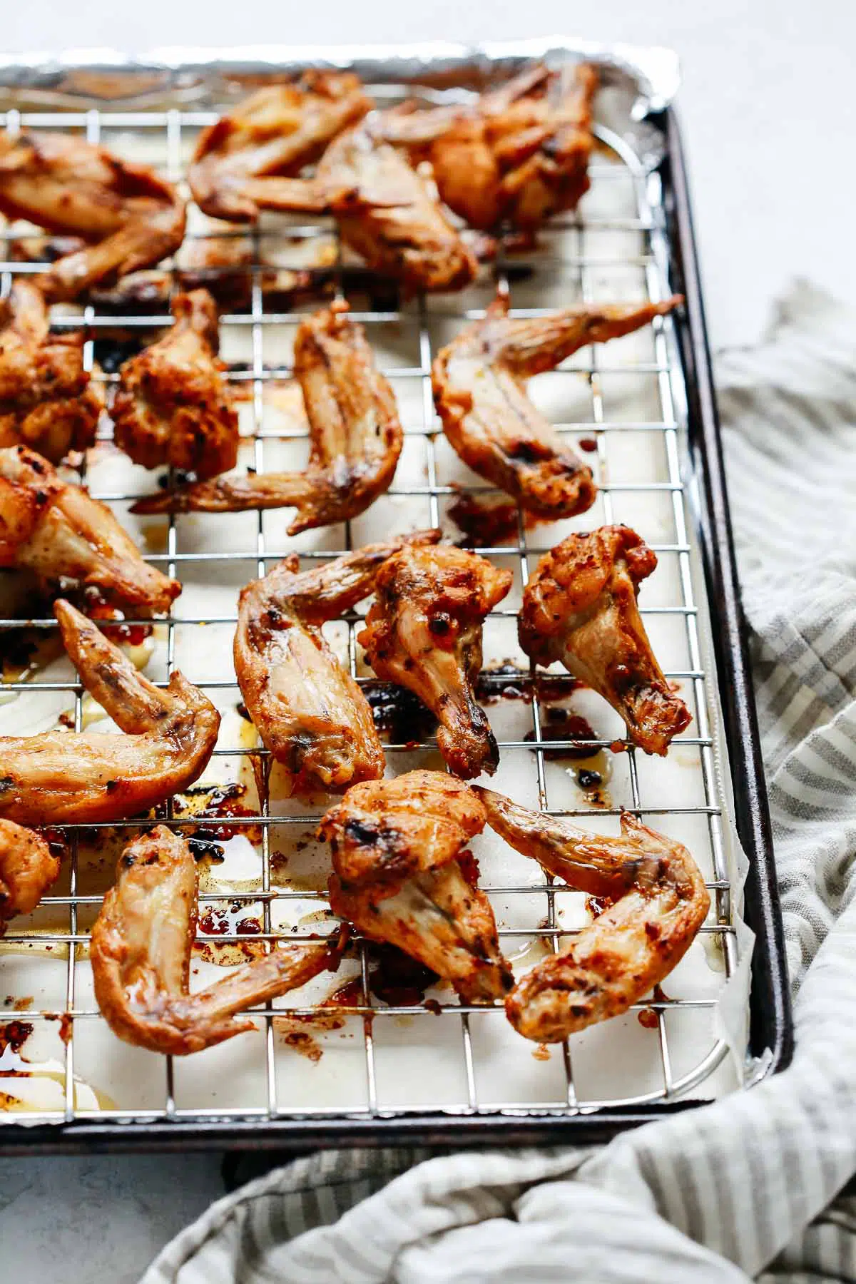 closeup of baked chicken wings on a wire rack baking sheep.