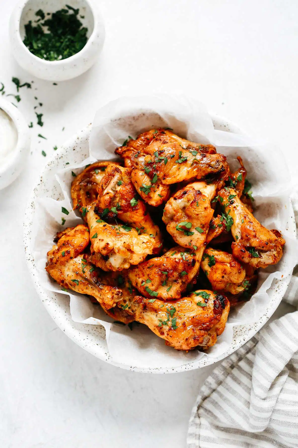 Overhead view of baked chicken wings in serving bowl