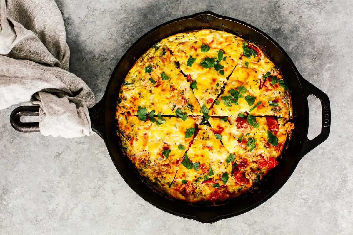 A finished vegetable frittata in a cast-iron skillet