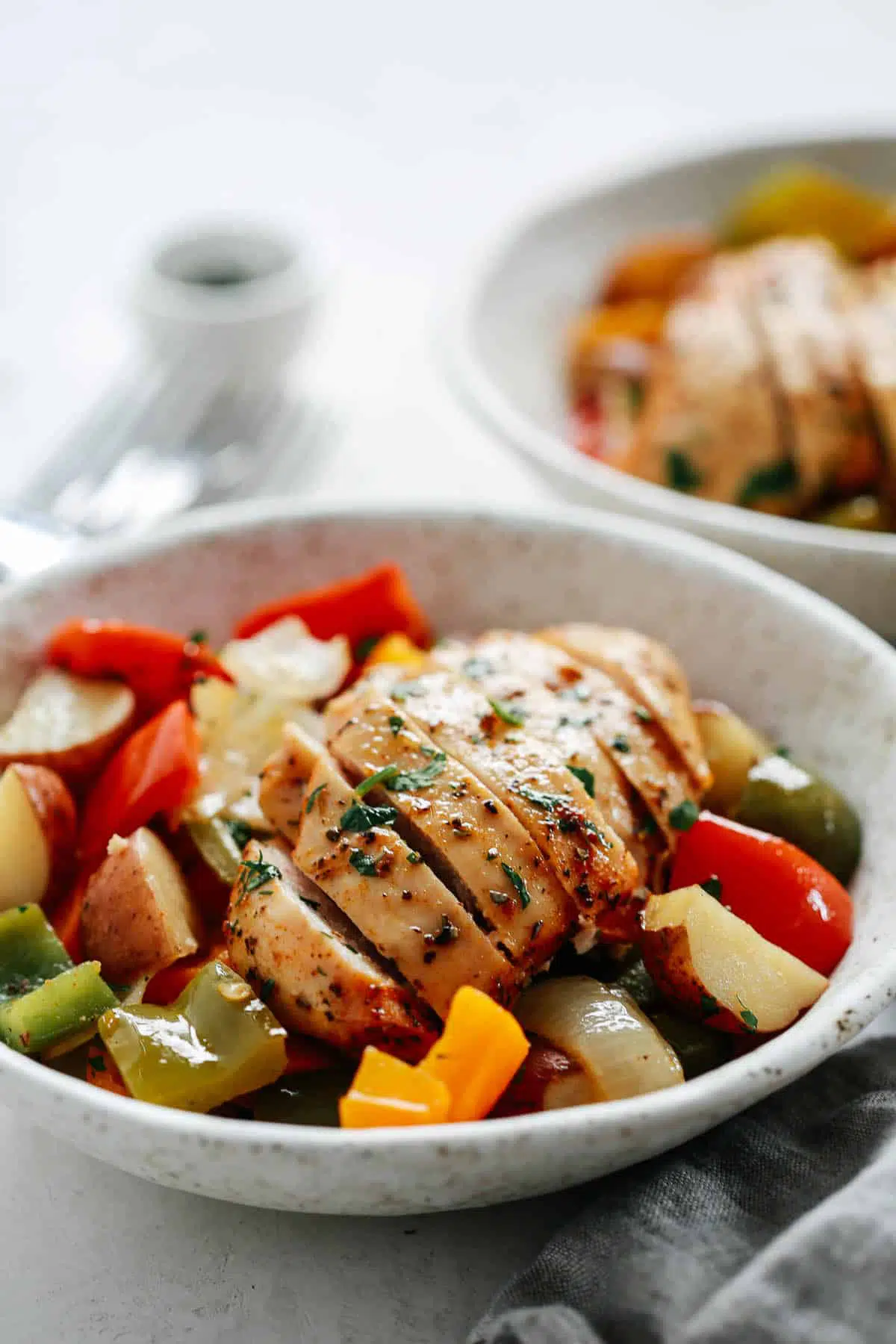 Chicken and veggies in a white plate