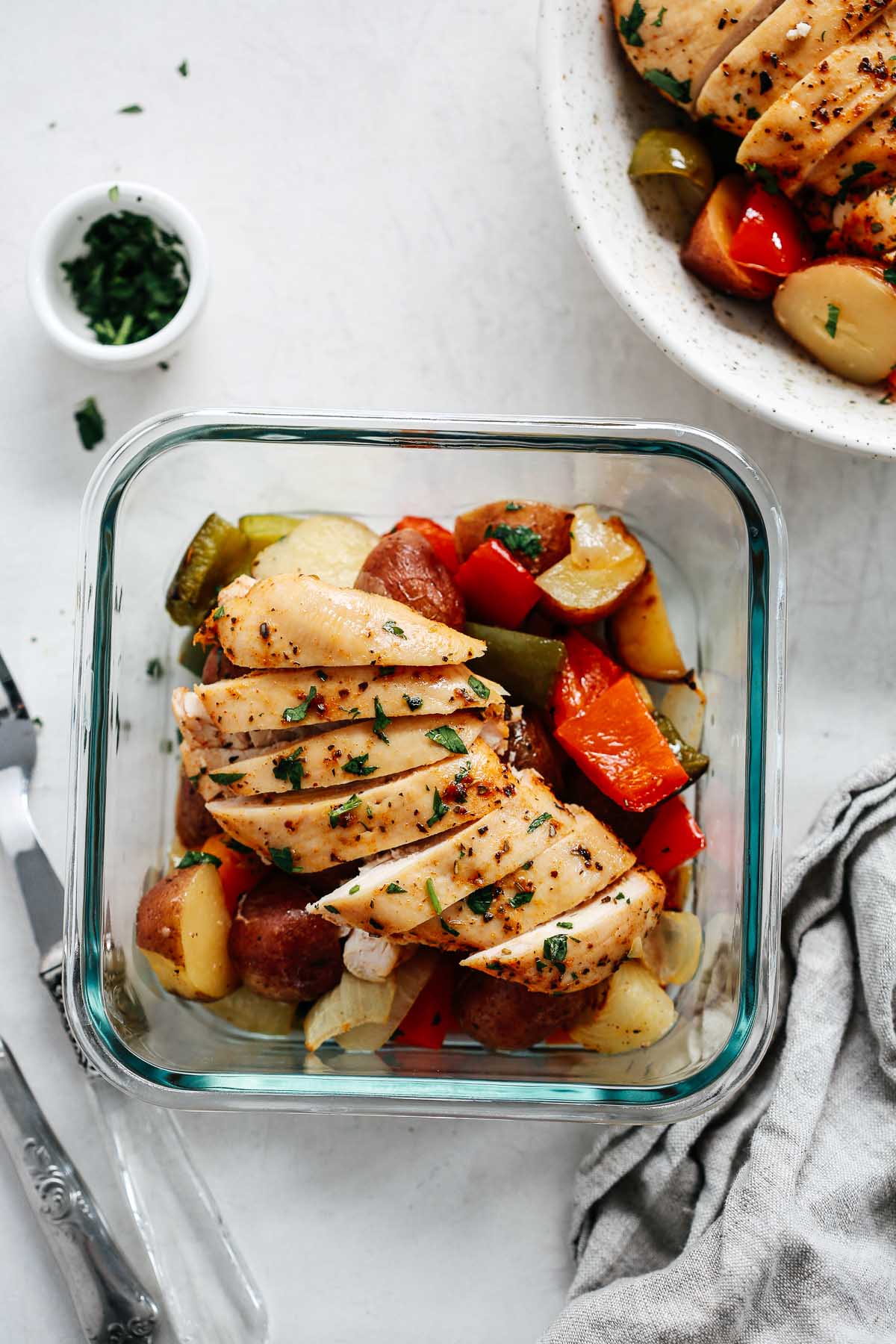 slices of roasted chicken breast in square meal prep container