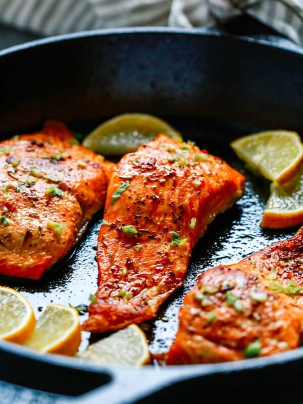 close up of broiled salmon in a cast iron skillet