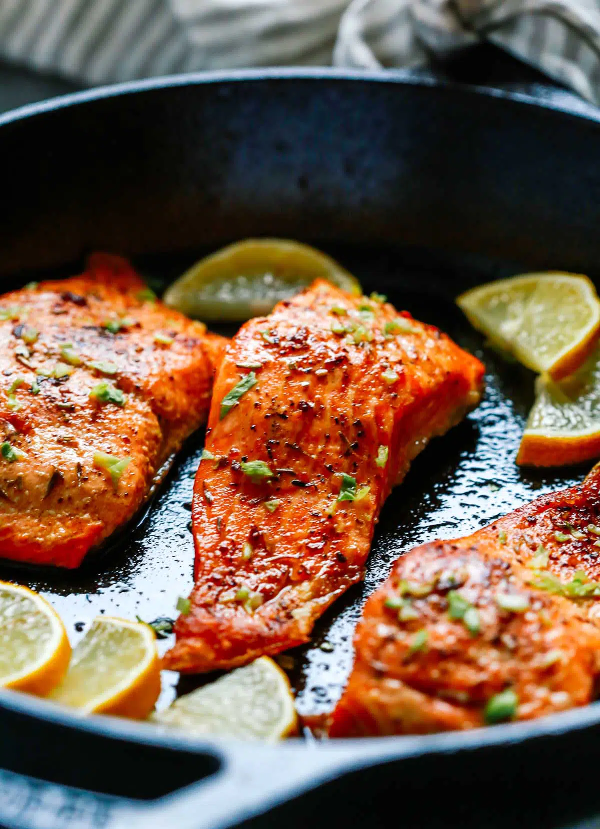 close-up of broiled salmon in a cast iron pan