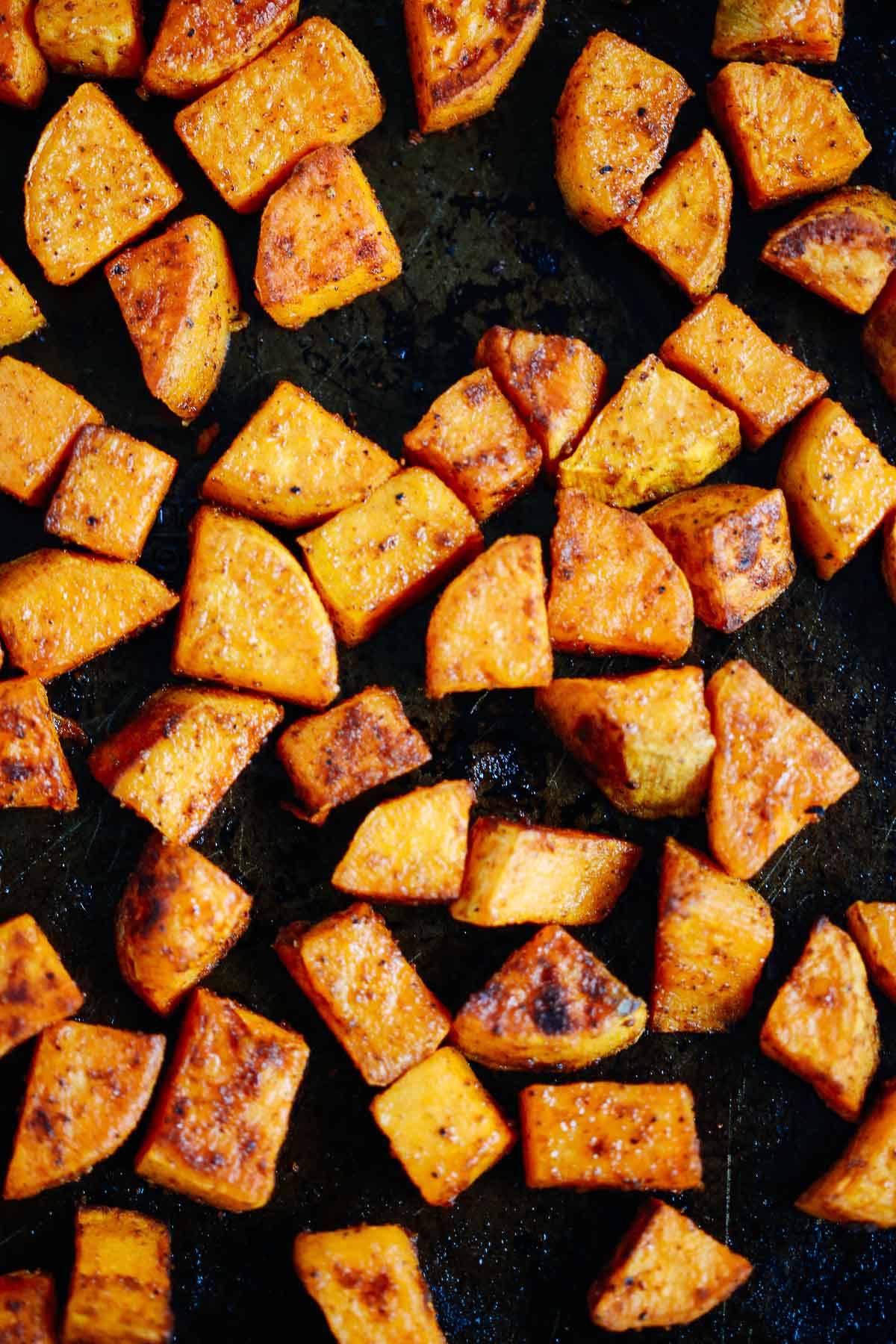 close up of roasted sweet potato on a baking tray