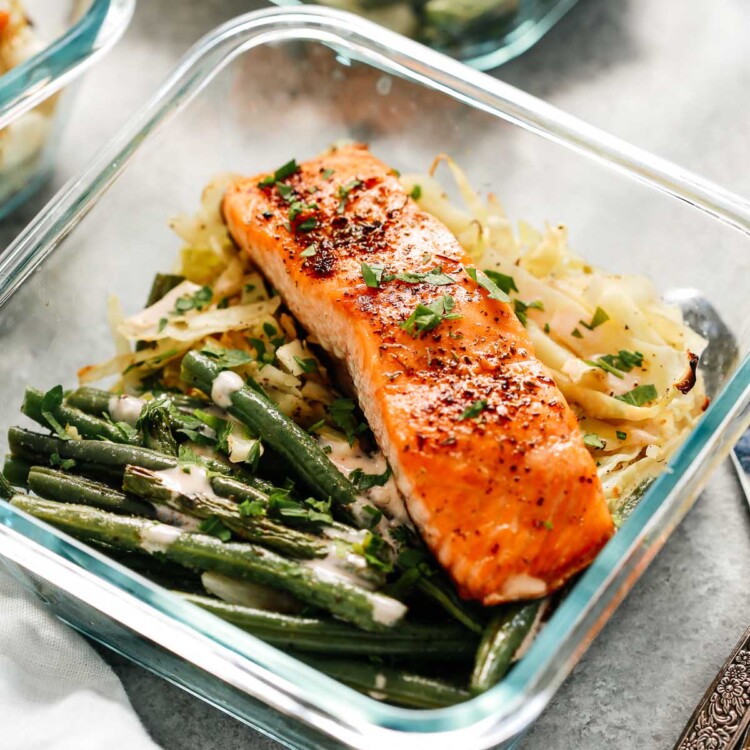 broiled salmon filet in meal prep container with green beans and cabbage