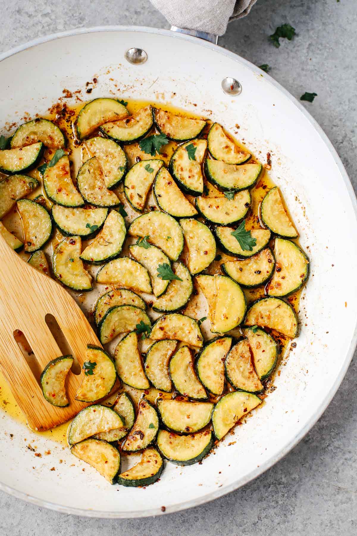 Overhead photo of garlic butter zucchini in a white pan.