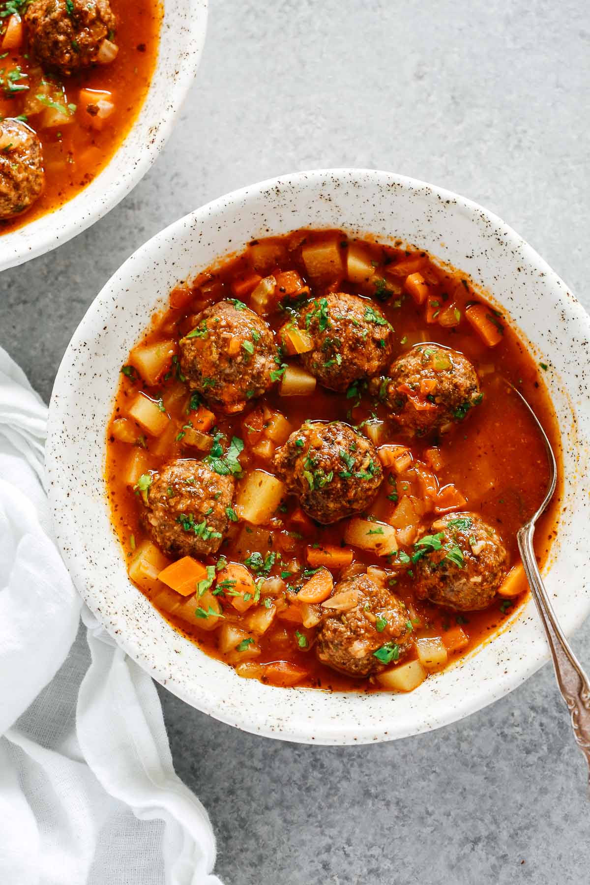 overhead view of a white bowl containing Meatball soup