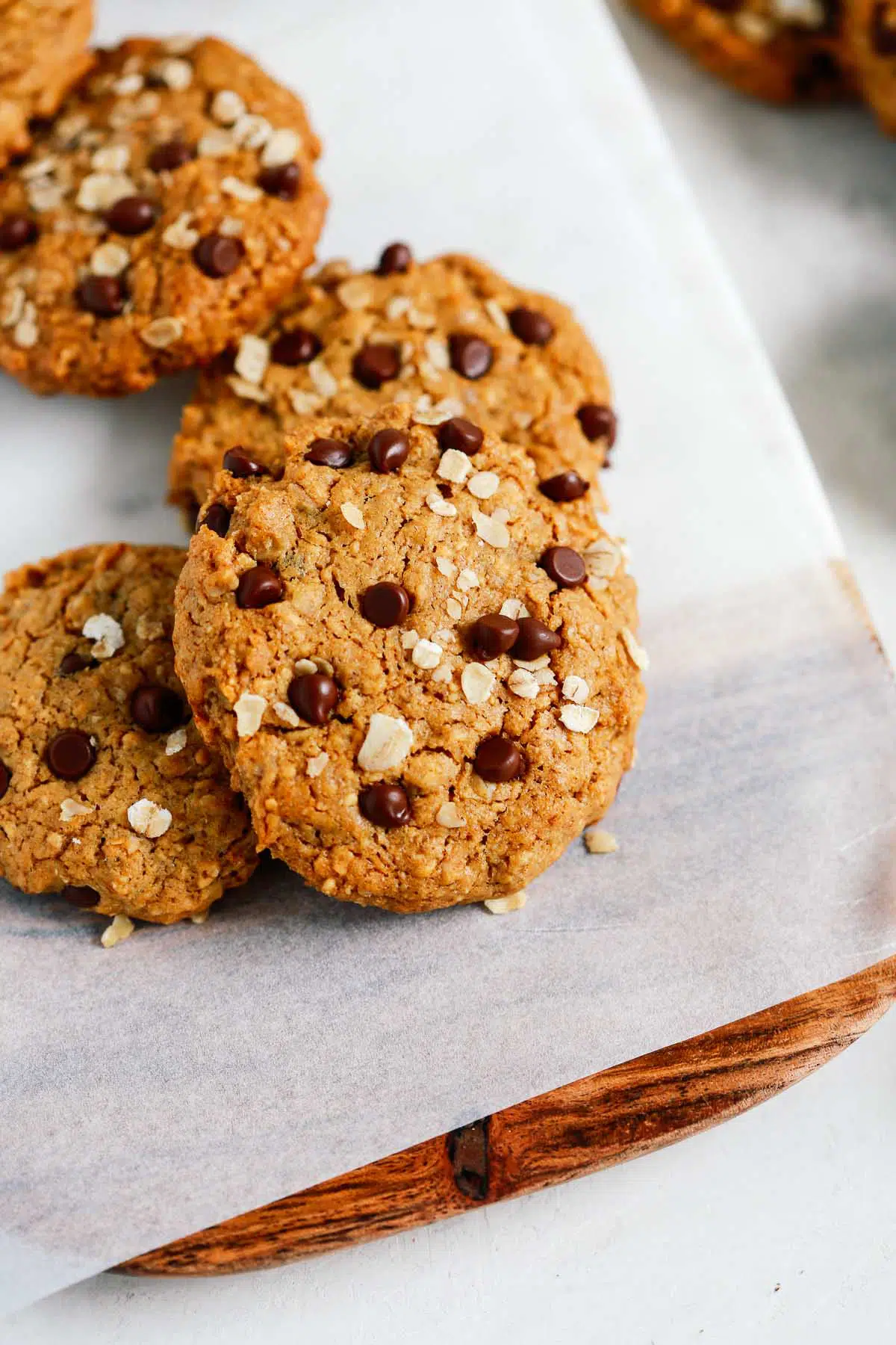 Peanut butter oatmeal cookies with chocolate chips on a cutting board