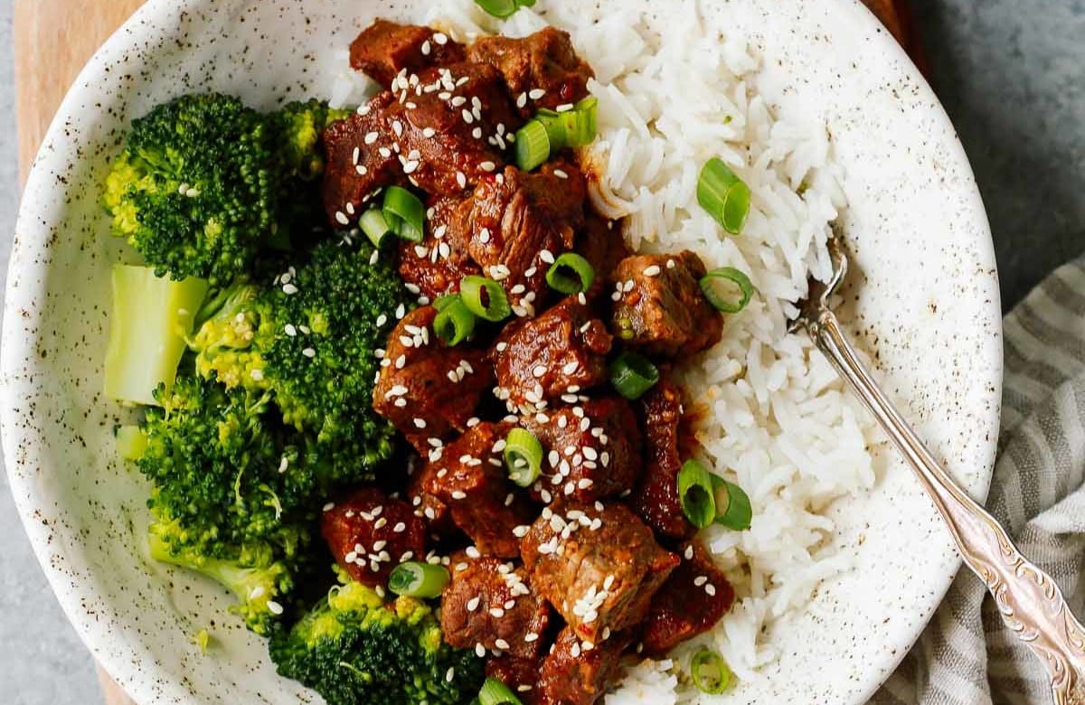 white place with Instant Pot Korean beef served over white rice with broccoli