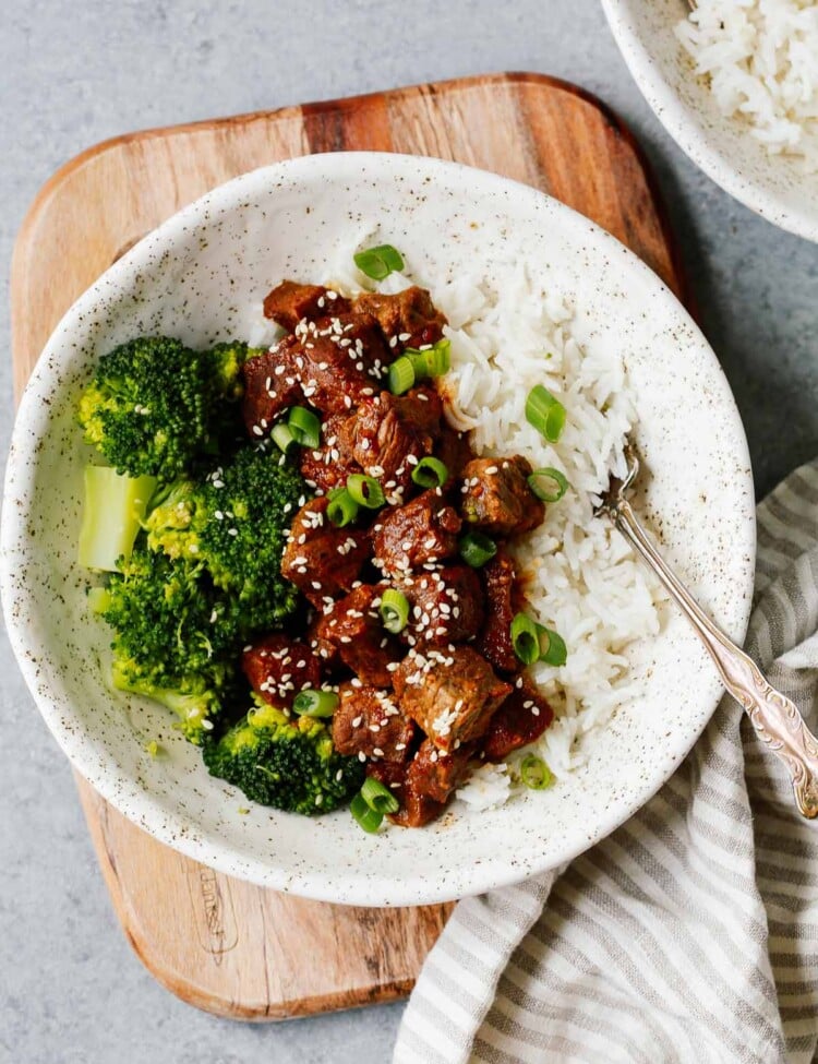 white place with Instant Pot Korean beef served over white rice with broccoli
