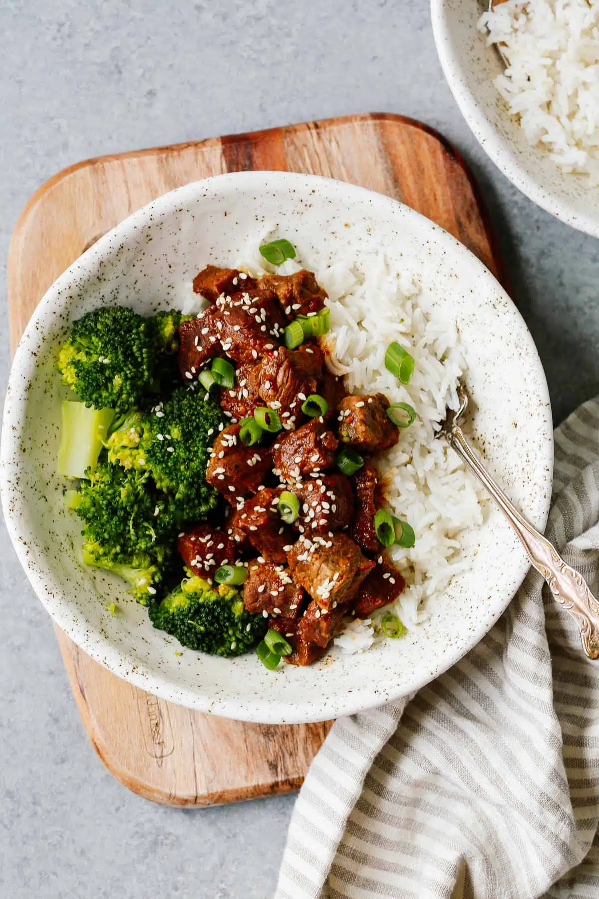 white place with Instant Pot Korean beef served over white rice with broccoli 