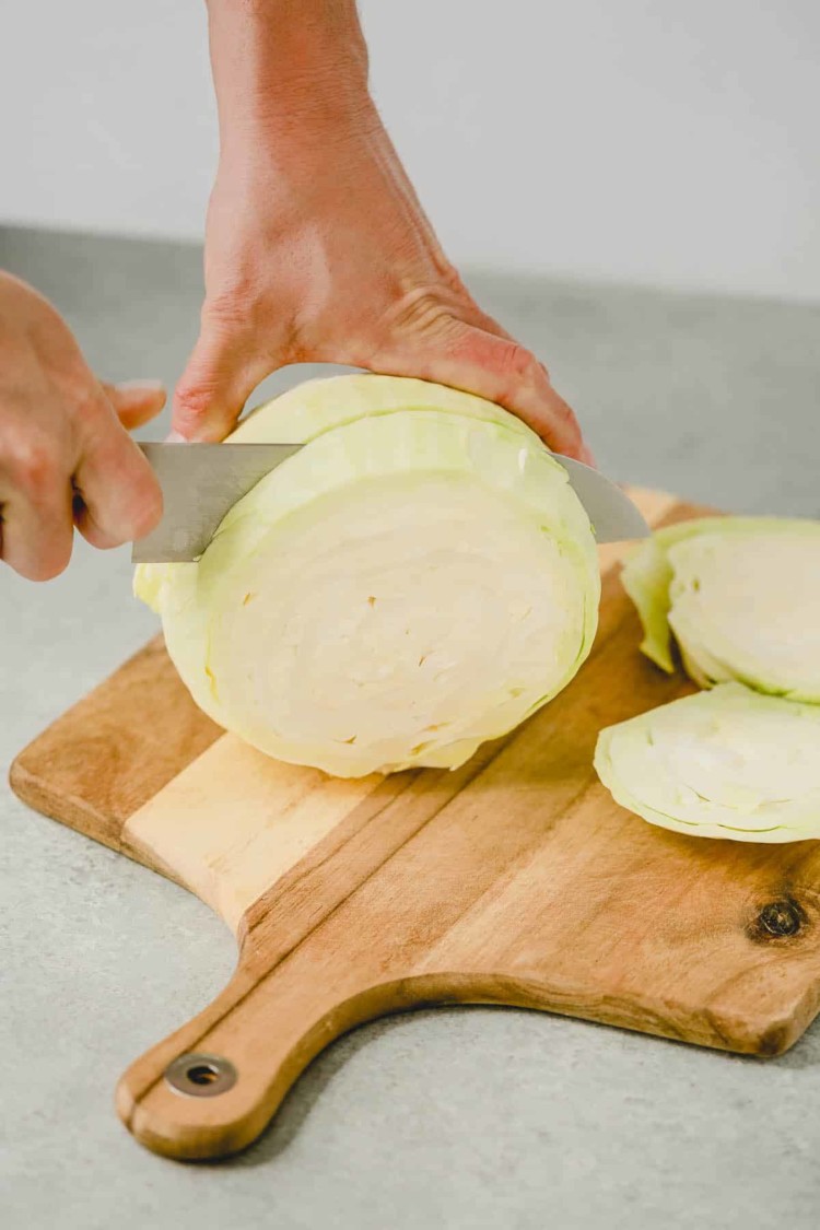 cutting cabbage on a wooden cutting board