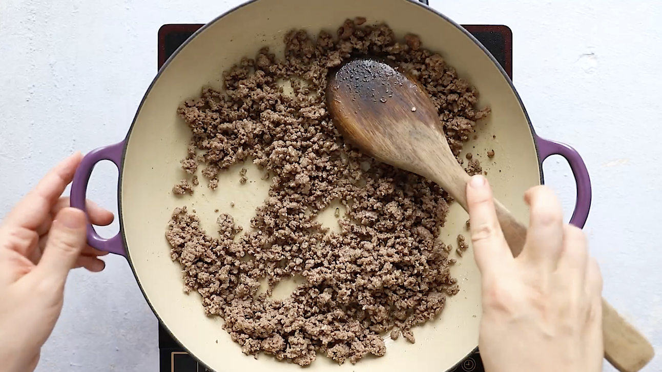 Ground beef, cabbage, and carrots stir-fried together in a skillet for Egg Roll in a Bowl.