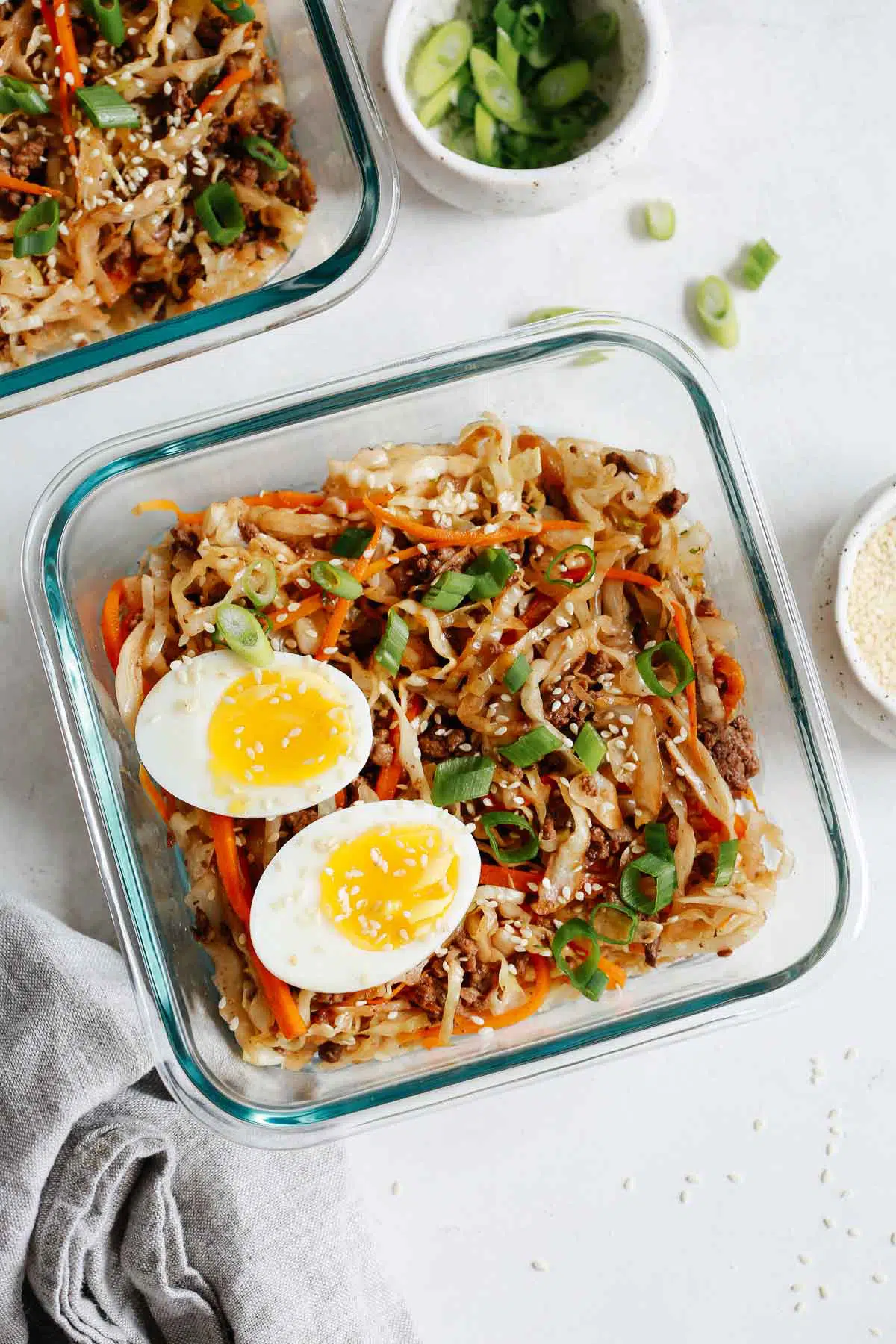 overhead view of an egg roll in a bowl recipe in a glass container