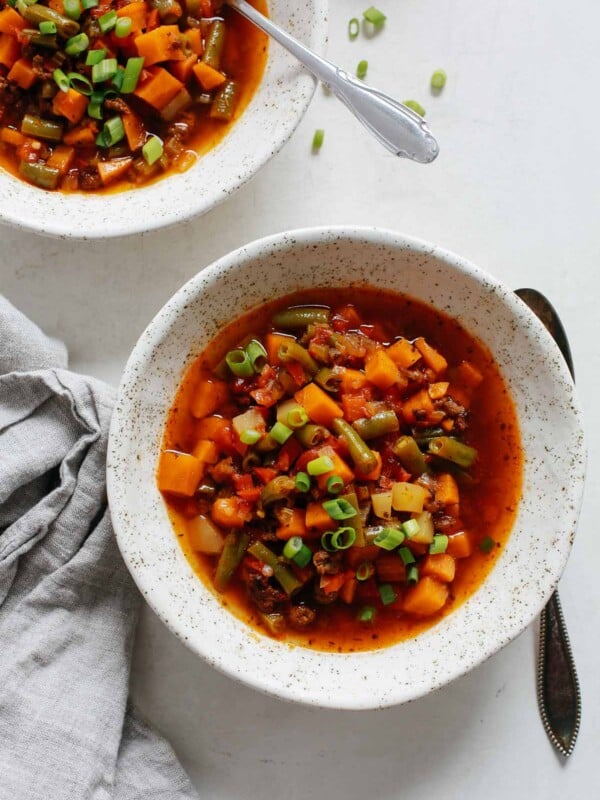 overhead view of a white bowl containing ground beef vegetable soup