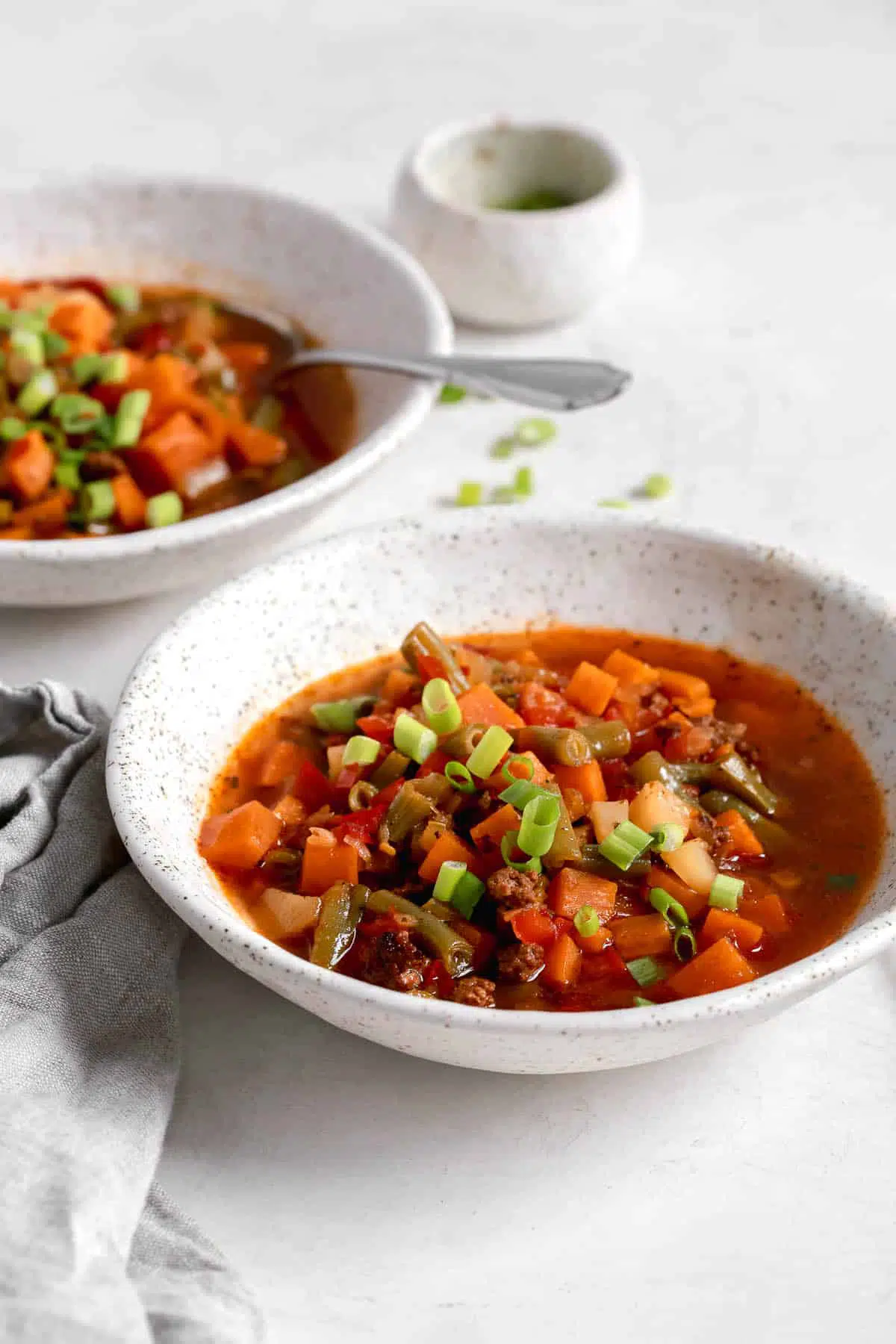 bowls of beef vegetable soup on a counter