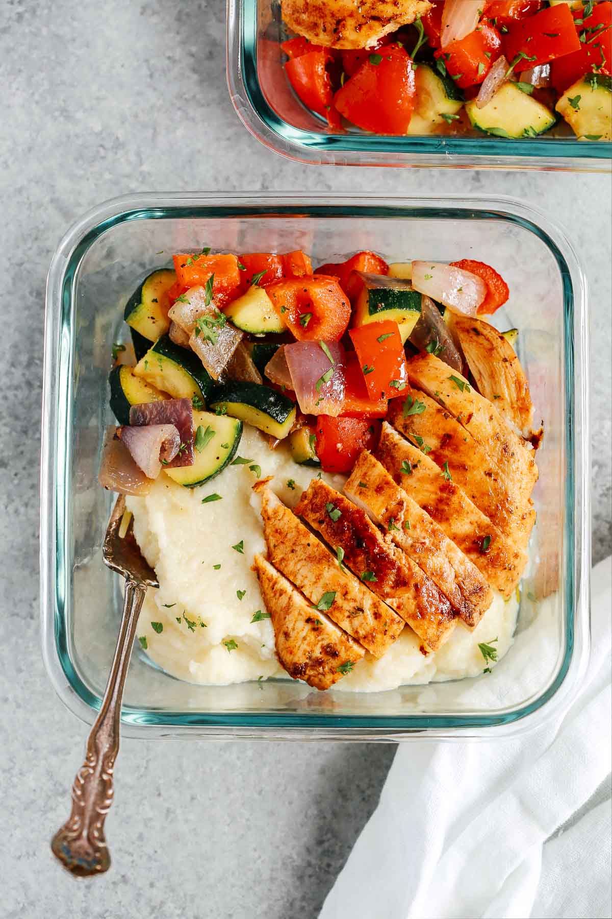 chicken breast with cauliflower mashed potatoes and steam vegetables in meal prep container