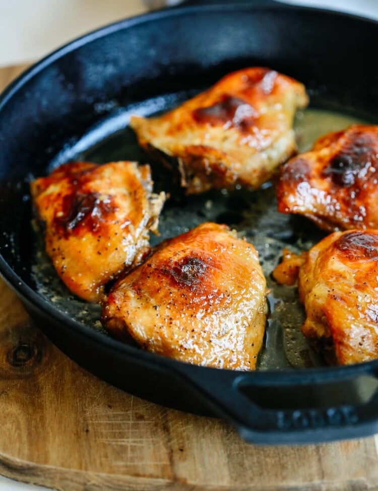 close up chicken thighs in a cast iron skillet