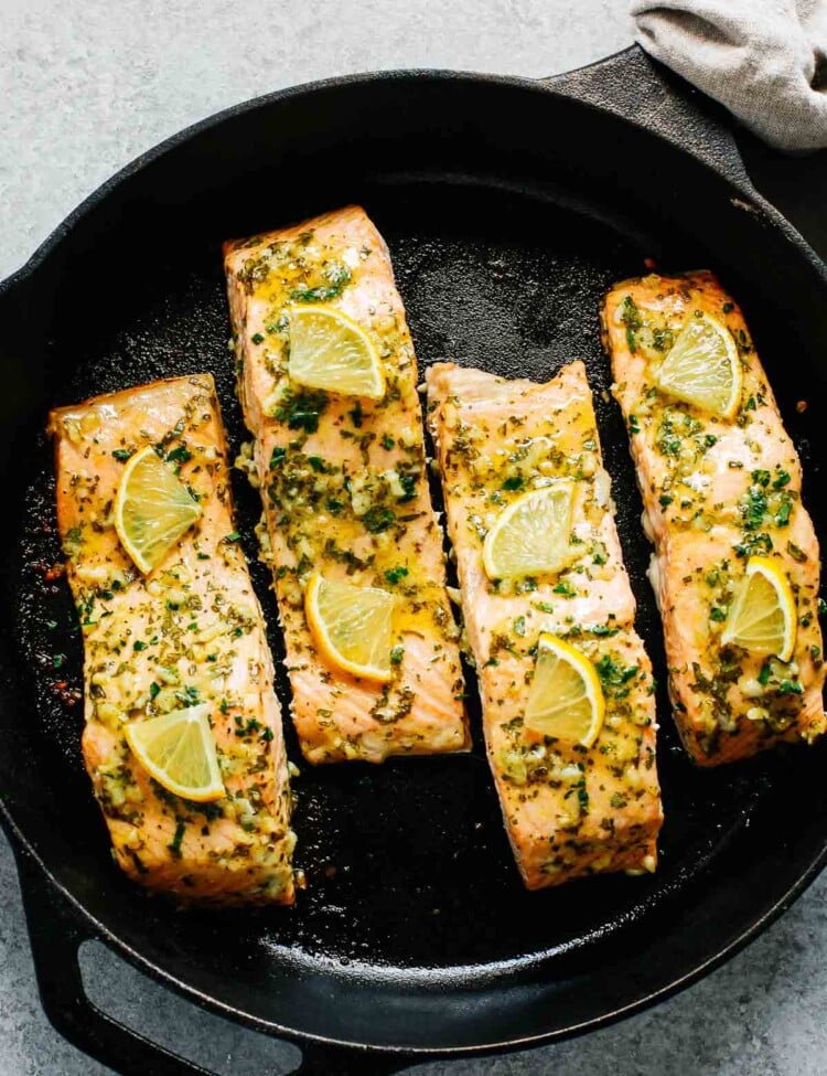 baked salmon with lemon in a cast iron skillet