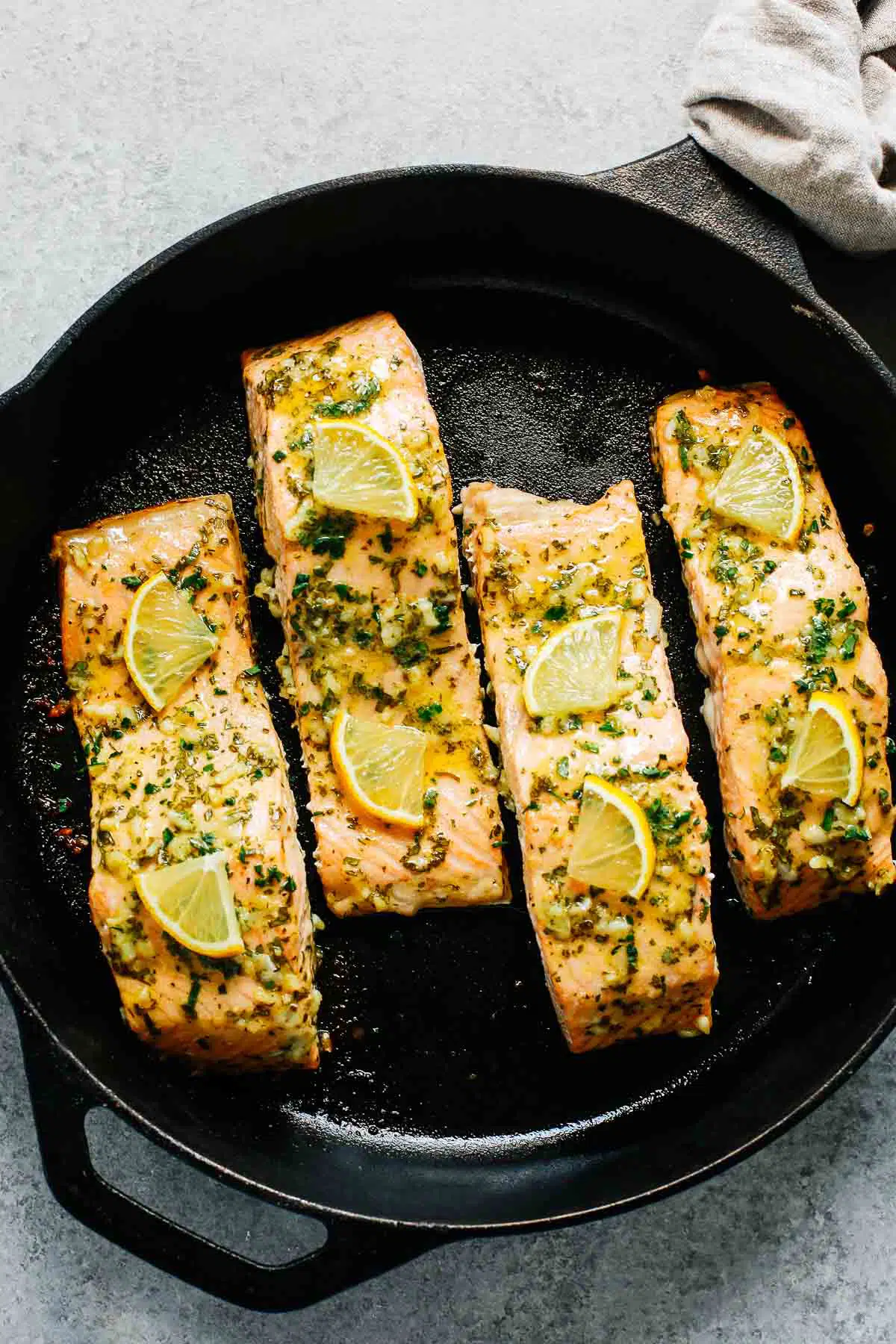 baked salmon with lemon in a cast iron skillet