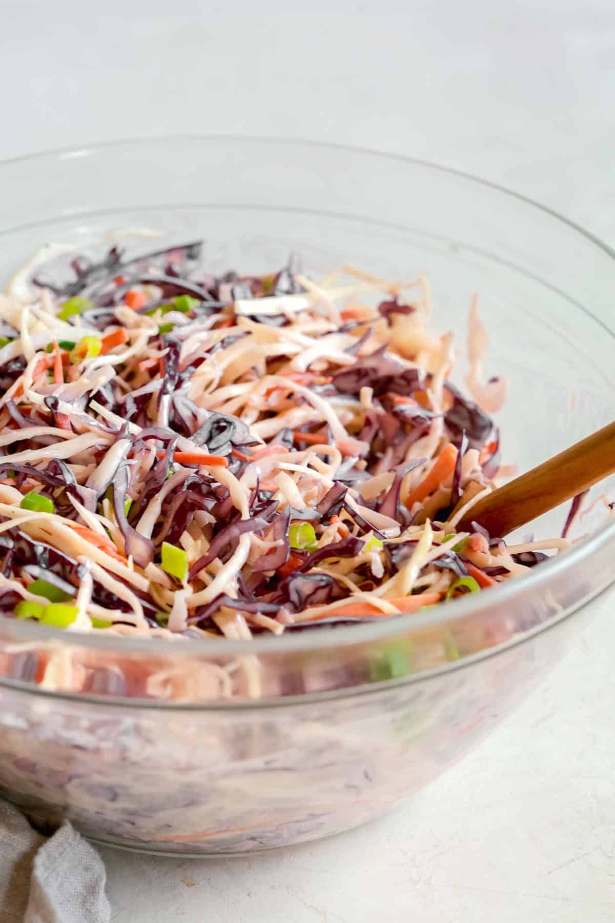 clear bowl of coleslaw salad with dressing