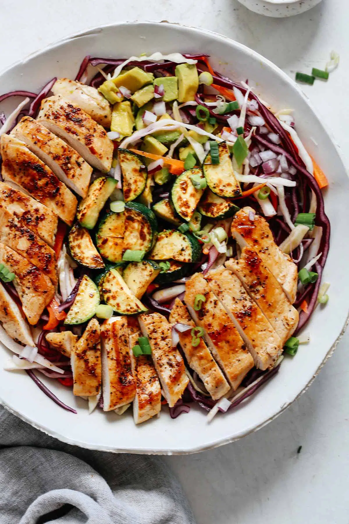 A closeup of chicken cabbage salad in a bowl.