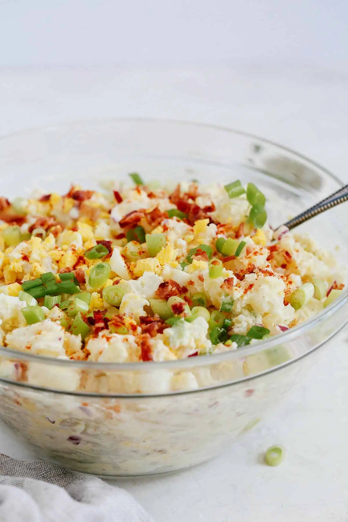 creamy potato salad in glass serving bowl