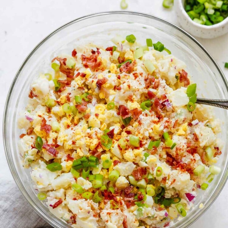 overhead view of a glass bowl containing potato salad