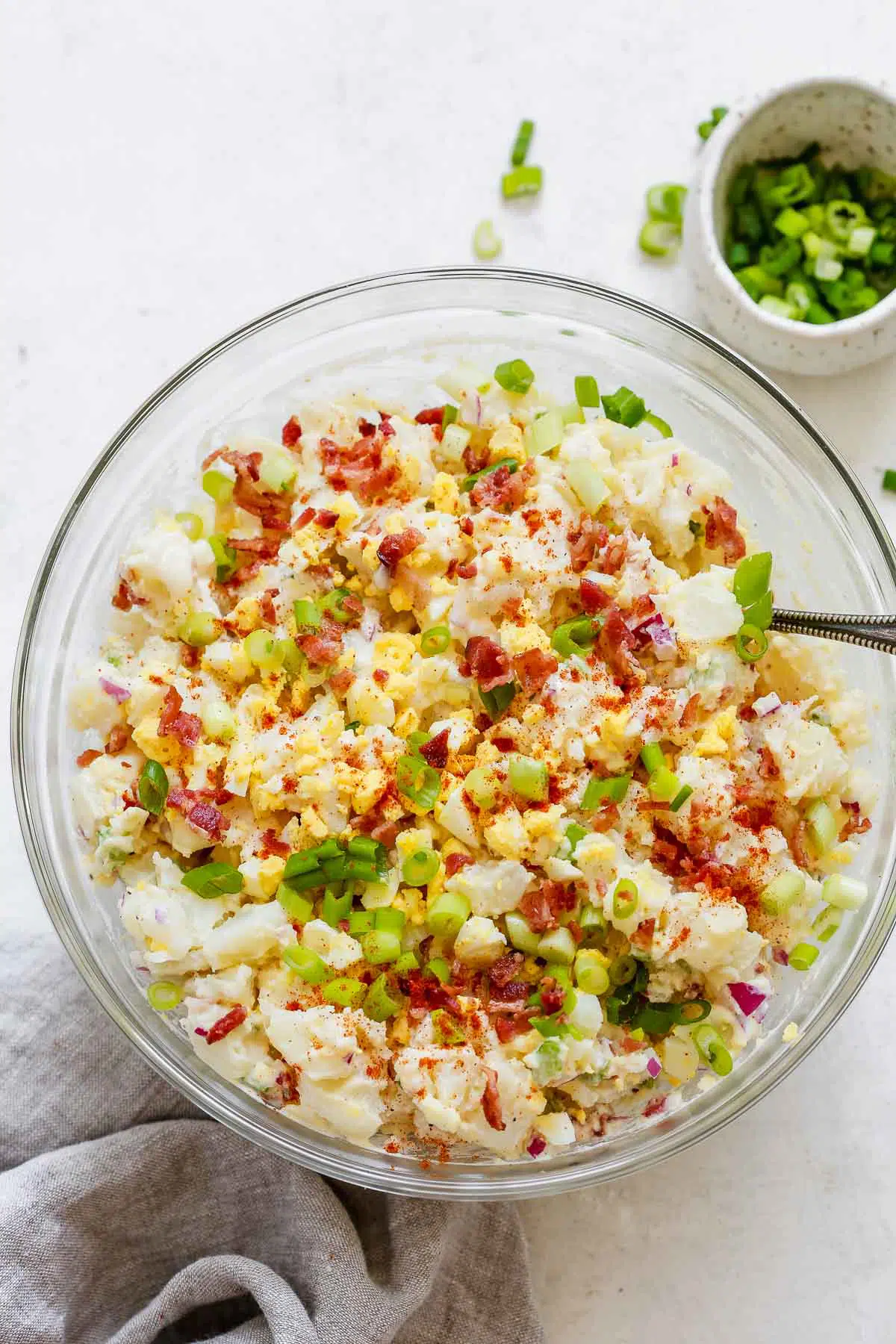 overhead view of a glass bowl containingĀ potato salad