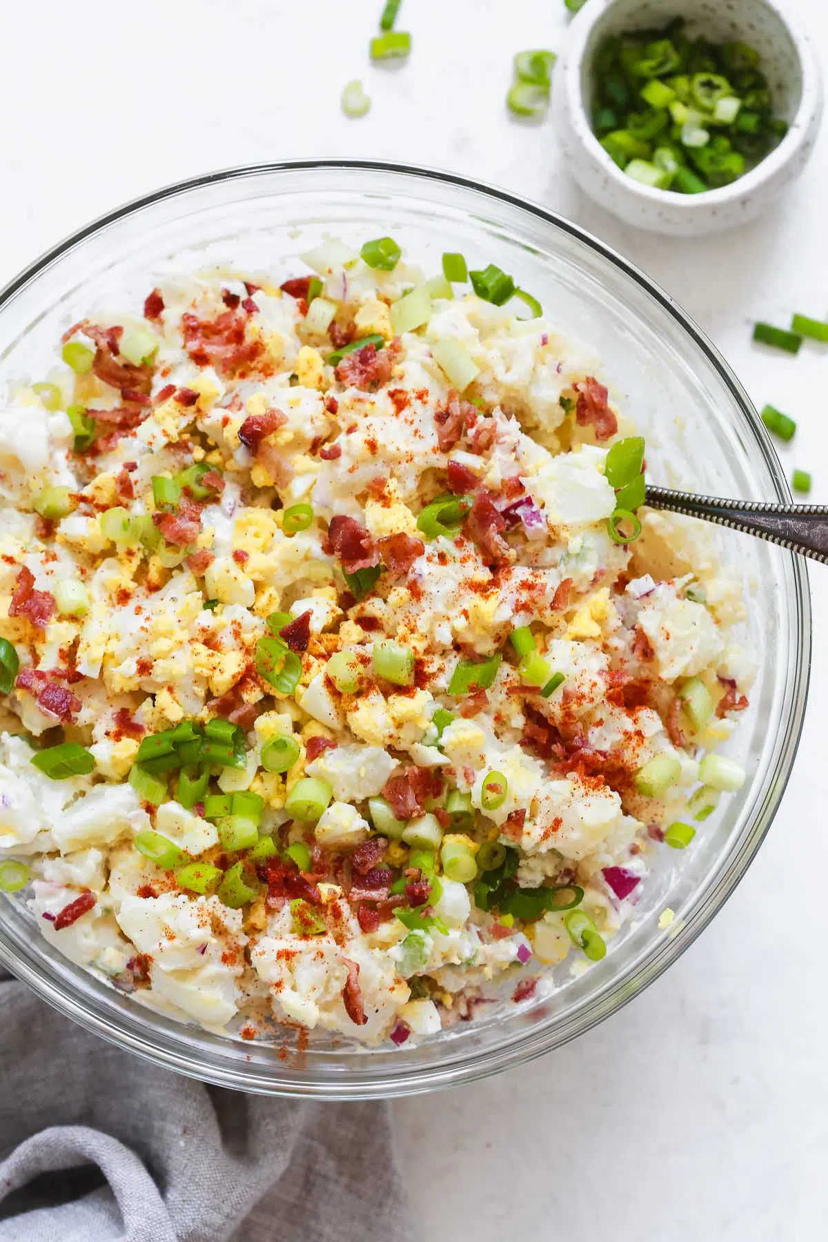 Overhead photo of a potato salad in a glass bowl.