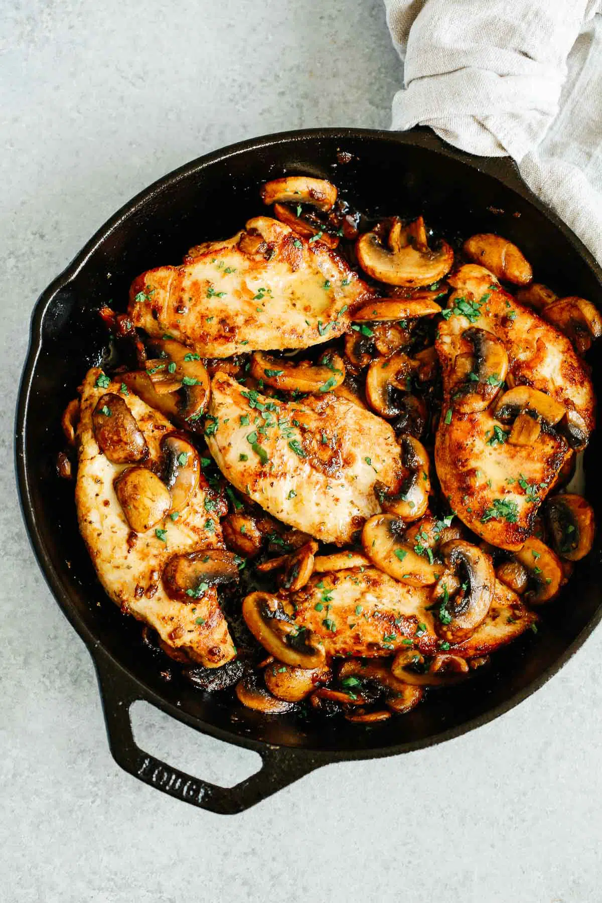overhead view of a cast iron skillet containing Mushroom Chicken Breast