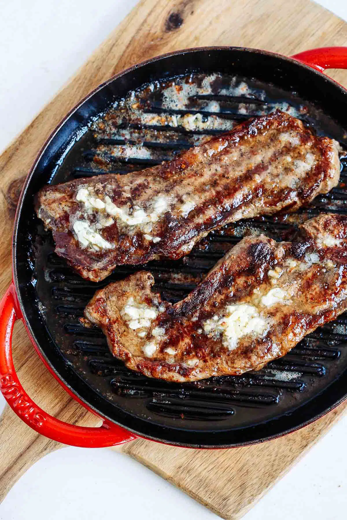 overhead photo of cooked skillet steaks 