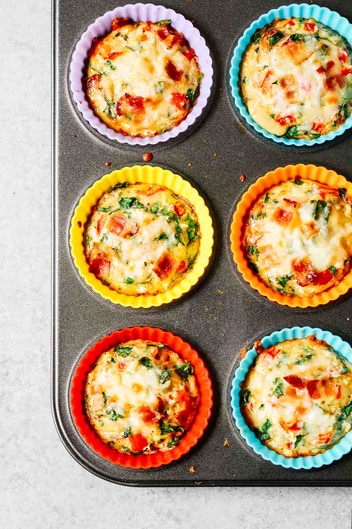 overhead image: 6 individual breakfast quiches baked in muffin pan
