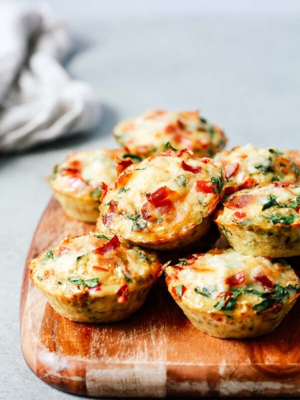 A close up of egg muffins on top of wooden serving board
